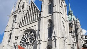 detailed view of historic architecture, ornate stonework and soaring spires captured beautifully, sunlit gothic cathedral with intricate sculptures and colorful roof tiles - Powered by Shutterstock - Get 15% off with code: PIKWIZARD15