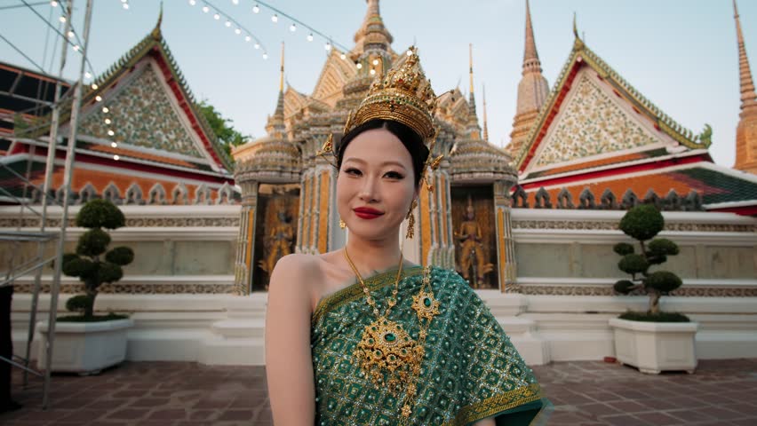 Portrait of thai woman in traditional costume, standing serenely at historic wat pho temple, embodying cultural heritage and spiritual