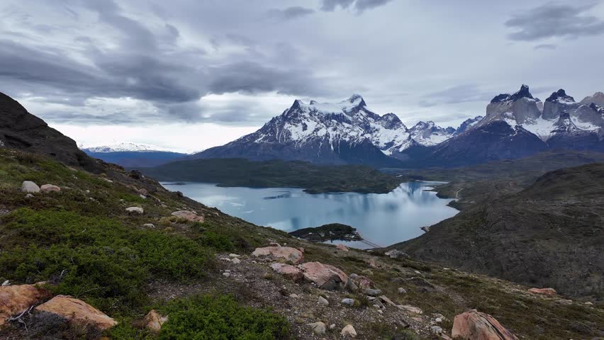 Torres del Paine, Chile:  Panorama from Mirador Condor in Torres del Paine National Park in Patagonia Region, Chile showing Cordillera del Paine and island in the background under dramatic sky