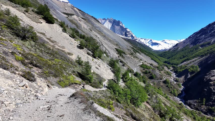 Torres del Paine, Chile: Point of view footage of walking on the rocky trail heading to Base Torres del Paine in Patagonia region, Chile with mountain in the background