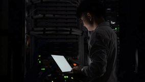 Computer engineer is setting up network in server room,Systems Maintenance Technician,Male engineer working in server room at modern data center - Powered by Shutterstock - Get 15% off with code: PIKWIZARD15