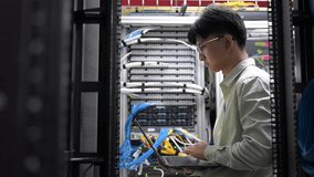 Computer engineer is setting up network in server room,Systems Maintenance Technician,Male engineer working in server room at modern data center - Powered by Shutterstock - Get 15% off with code: PIKWIZARD15