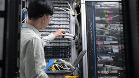 Computer engineer is setting up network in server room,Systems Maintenance Technician,Male engineer working in server room at modern data center - Powered by Shutterstock - Get 15% off with code: PIKWIZARD15