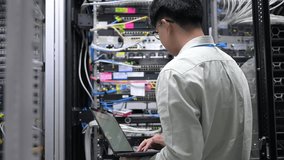 Computer engineer is setting up network in server room,Systems Maintenance Technician,Male engineer working in server room at modern data center - Powered by Shutterstock - Get 15% off with code: PIKWIZARD15