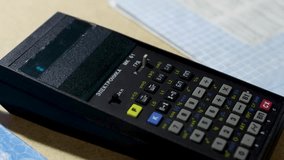 A finger types numbers on the keyboard of a vintage calculator - Powered by Shutterstock - Get 15% off with code: PIKWIZARD15