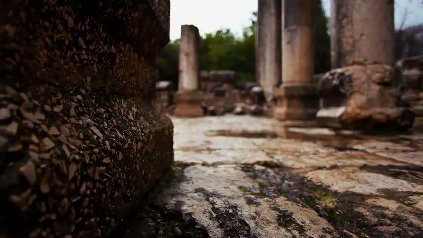 Ancient stone ruins and rock walls surrounded by lush greenery, capturing historic architecture, natural vegetation, and the timeless beauty of abandoned structures.
