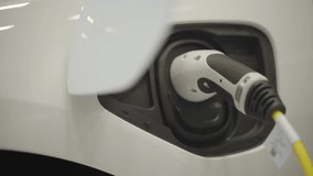 Electric car charging at an urban station, highlighting sustainable transportation, clean energy, and modern eco-friendly city mobility solutions. - Powered by Shutterstock - Get 15% off with code: PIKWIZARD15