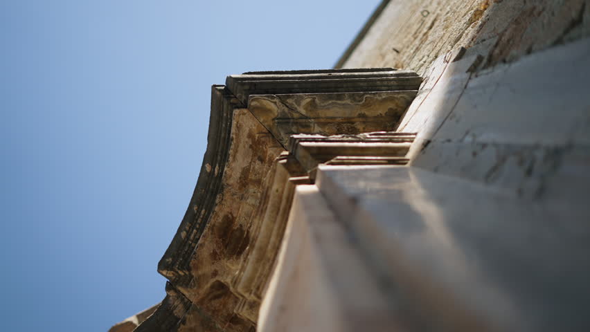 Historic Stone Cornice Detail Under Bright Blue Sky