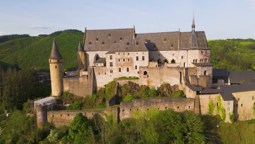 vianden castle chateau de historical site green hills cloudy sky town homes cars old windows domes luxembourg to left around near right circles drone
