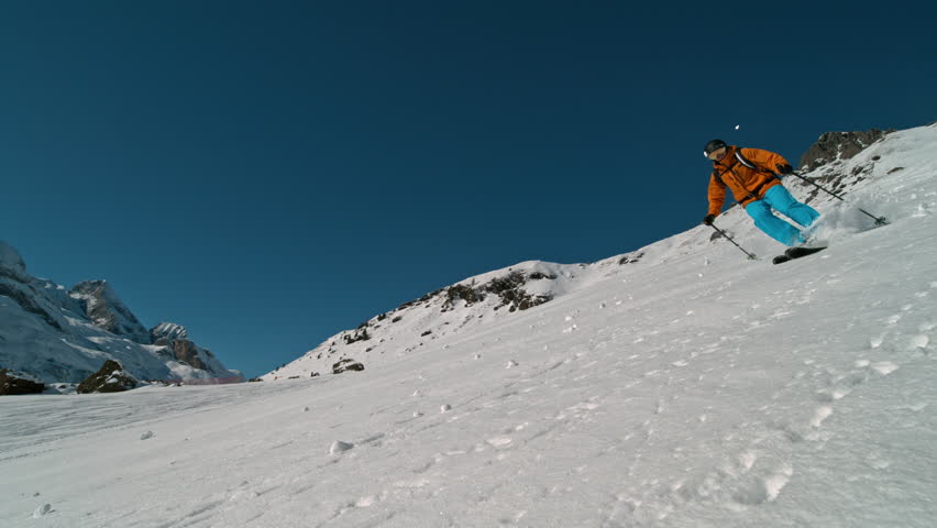 Skier riding in the scenic Dolomites mountains in fresh powder snow. Super slow motion at 1000 fps.