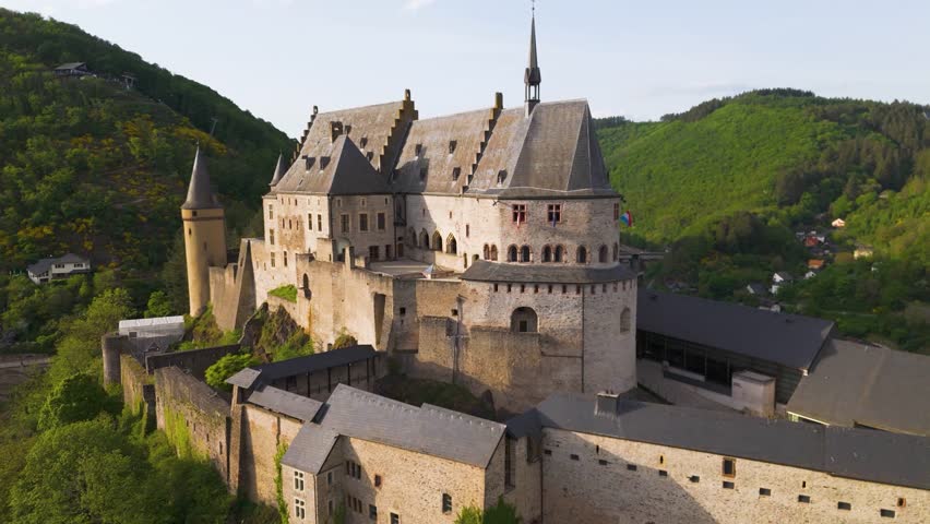 vianden castle chateau de round arches historic site green hills surrounding area along beautiful homes valley pull drone shot back luxembourg