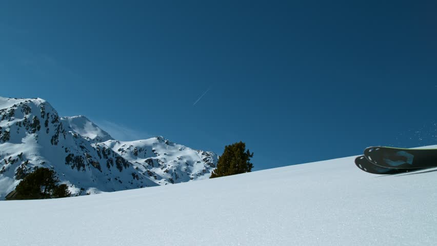 Skier riding in the scenic Dolomites mountains in fresh powder snow. Super slow motion at 1000 fps.