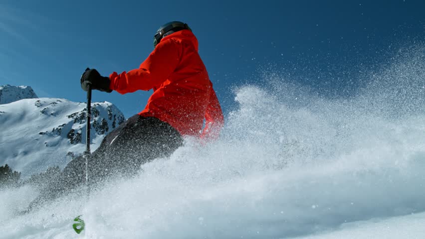 Skier riding in the scenic Dolomites mountains in fresh powder snow. Super slow motion at 1000 fps.