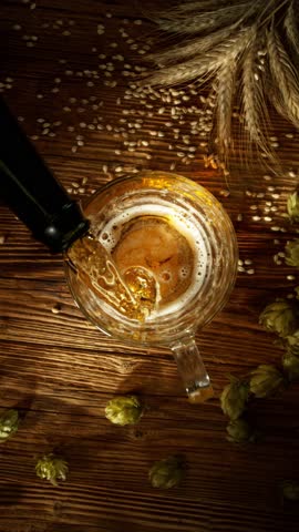 Super Slow Motion of Pouring Beer into Pint Glass , Top Down View . Filmed on High Speed Cinema Camera , 1000 FPS