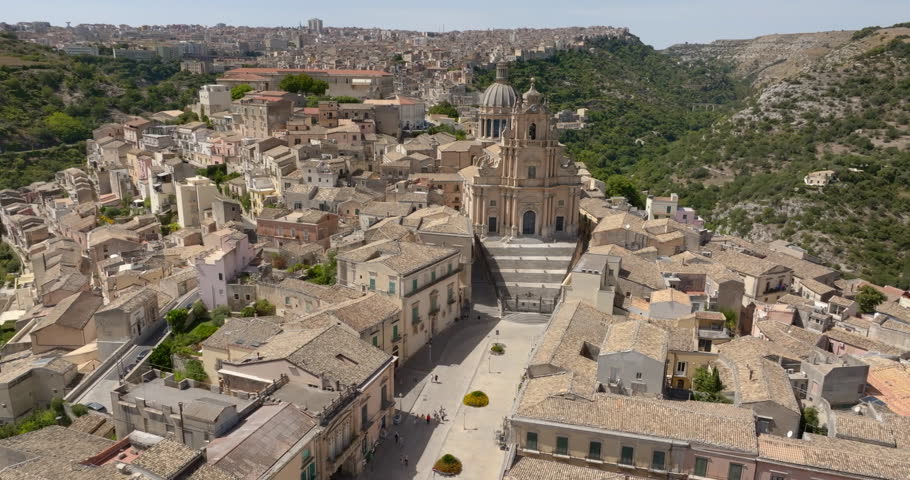 Aerial view of the Cathedral of San Giorgio, located in the historic center of the old town of Ragusa Ibla, Sicily, Italy. Example of Baroque architecture, it features a wide staircase at its entrance