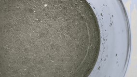 A mesmerizing, extreme close-up, top-down view of a thick, yellowish liquid filled with numerous small and large bubbles, suggesting foam, carbonation, a chemical reaction, or oil mixed with water - Powered by Shutterstock - Get 15% off with code: PIKWIZARD15