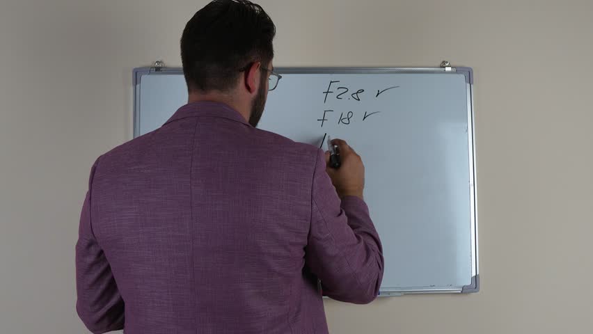 The man in the image is actively gesturing while presenting information.