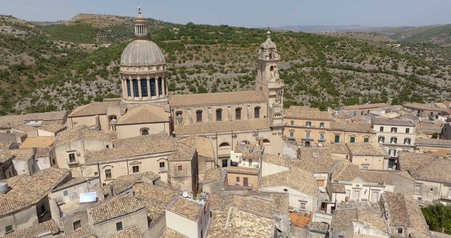 Aerial closeup of the Cathedral of San Giorgio, located in the historic center of Ragusa Ibla, Sicily, Italy. It is a Catholic church with a beautiful facade, an example of Baroque architecture.