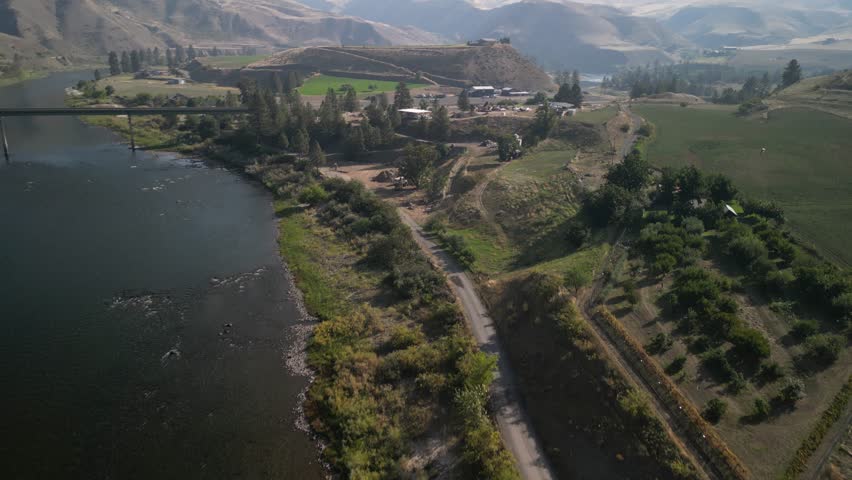 Aerial of birds above rural properties in White Bird Idaho on sunny fall day