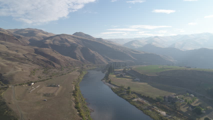 High aerial above rural properties in White Bird Idaho along US 95 on hazy fall day