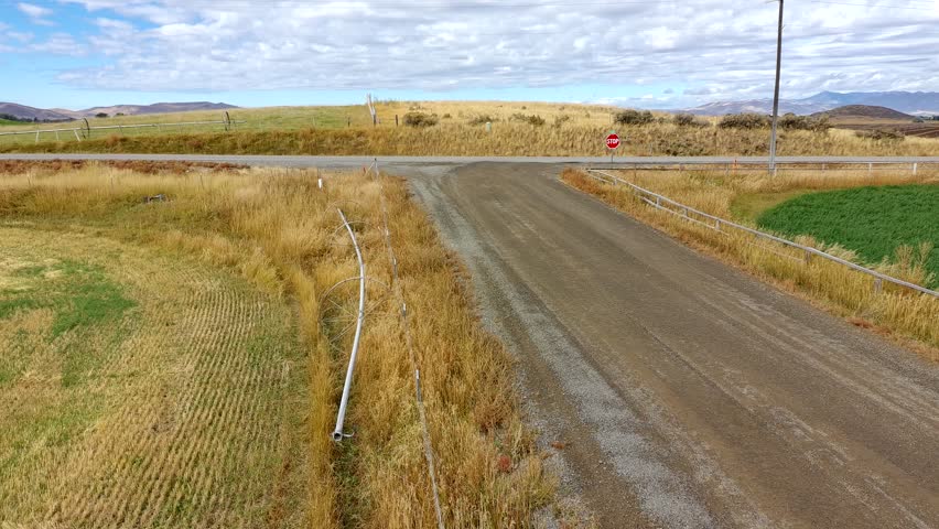 Drone clip of a Rural dirt road in farmland in Idaho