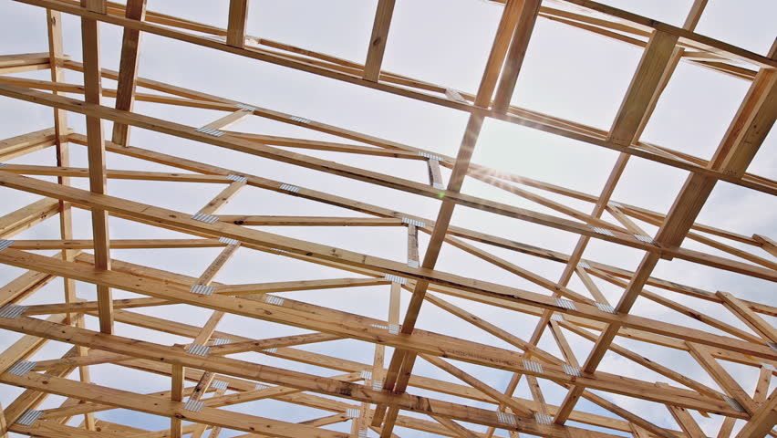 Wooden rafters are arranged to form roof beams structure, building process