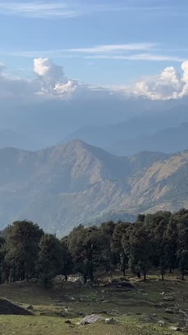 Mountain landscape in Uttarakhand, India
A calm mountain landscape with trees and layered hills in Uttarakhand, India, captured during daylight. The scene shows natural terrain, clouds, and forested s