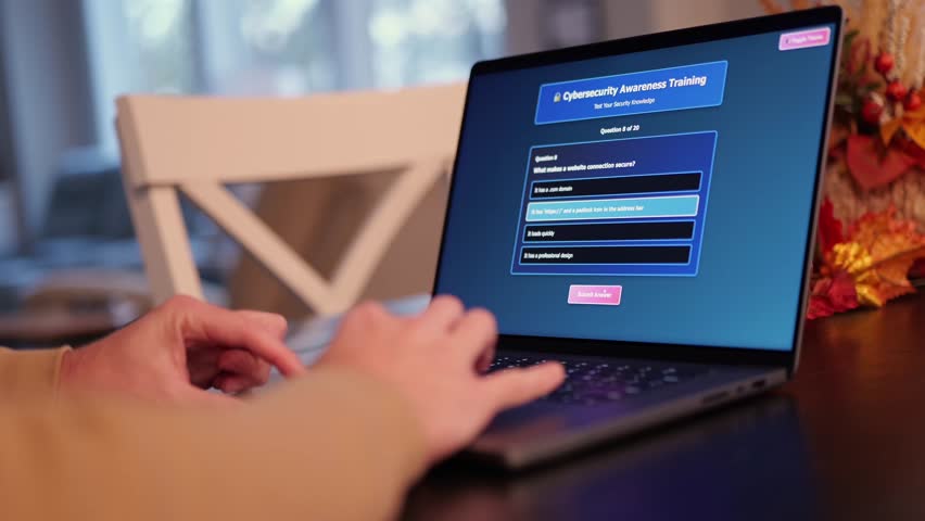Middle Aged Man Working from Home Takes IT Security Awareness Training from Kitchen Table - Cybersecurity Education for Remote Employees Concept