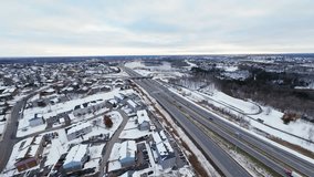 FPV aerial view of a winter highway interchange. Dynamic traffic, snowy roads, city suburbs and a wide cinematic landscape captured in smooth FPV motion. - Powered by Shutterstock - Get 15% off with code: PIKWIZARD15