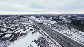 FPV aerial view of a winter highway interchange. Dynamic traffic, snowy roads, city suburbs and a wide cinematic landscape captured in smooth FPV motion. - Powered by Shutterstock - Get 15% off with code: PIKWIZARD15