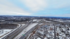 FPV aerial view of a winter highway interchange. Dynamic traffic, snowy roads, city suburbs and a wide cinematic landscape captured in smooth FPV motion. - Powered by Shutterstock - Get 15% off with code: PIKWIZARD15