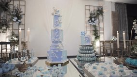 Orbiting shot around blue birthday cakes, macarons and pastries on reflective table - Powered by Shutterstock - Get 15% off with code: PIKWIZARD15