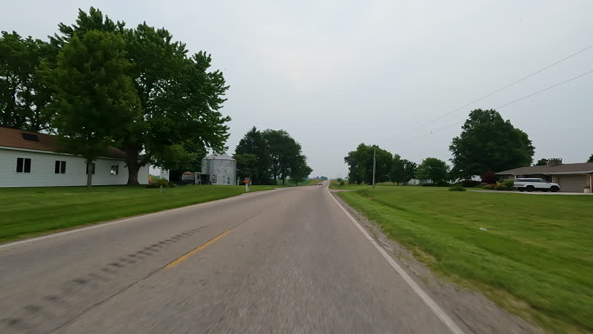 Idyllic views of rural life driving through the countryside on a rural road surrounded by agricultural fields, horse stables and farms. Located in the heart of Illinois Amish country - Arthur, IL.