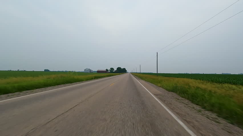 Idyllic views of rural life driving through the countryside on a rural road surrounded by agricultural fields and farms. Located in the heart of Illinois Amish country - Arthur, Illinois.