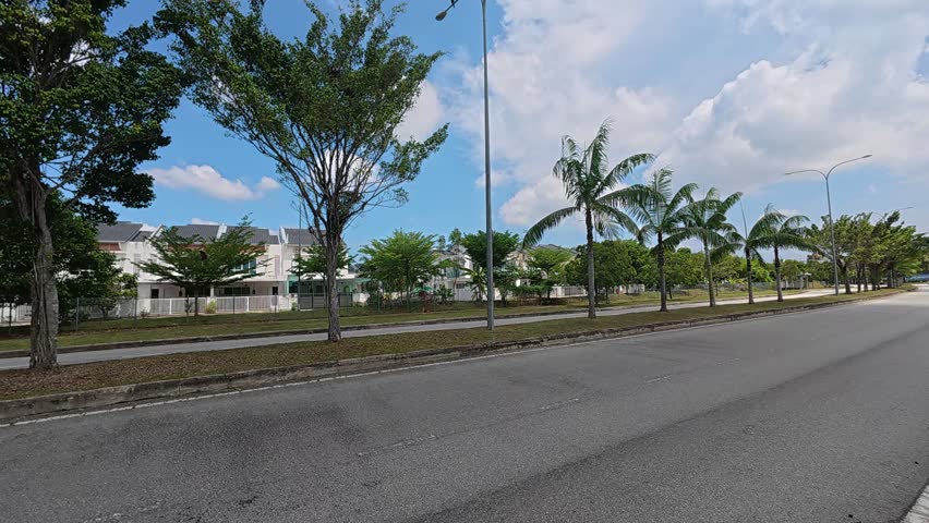 Decorative trees line the road median and roadside edges. They provide shade for both commuters and pedestrians using the area. These trees also function as a natural safety barrier during accidents.