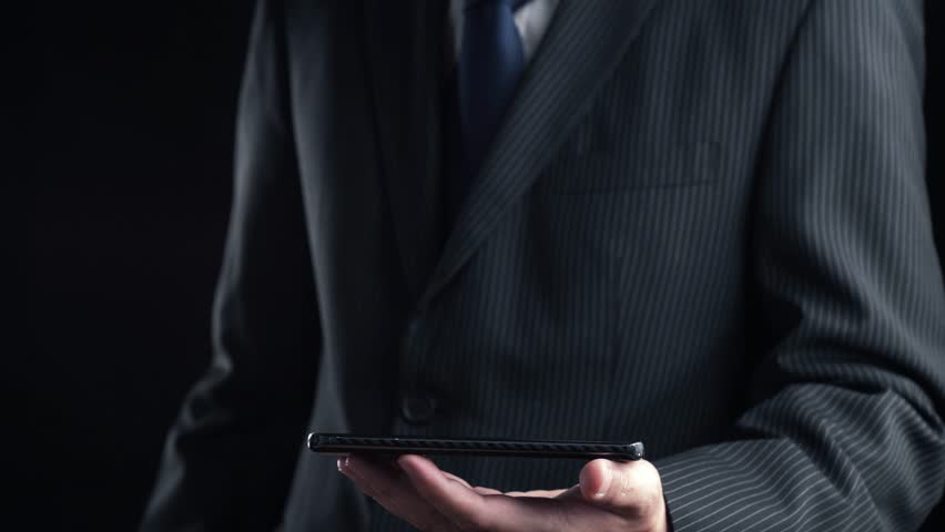 A businessman in a formal suit holds a smartphone displaying a vibrant rocket icon and various digital symbols, symbolizing innovation, growth, and the startup journey. Qubit
