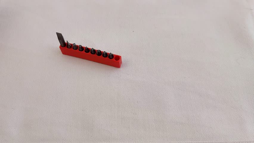 Bright pink plastic case holds assorted screwdriver bits, neatly organized for quick access, handy storage, and ready use in DIY projects or everyday repairs