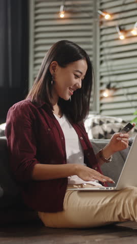 slow motion vertical asian woman paying online with credit card laptop e commerce shopping smart money finance freedom fintech home lifestyle happiness digital world