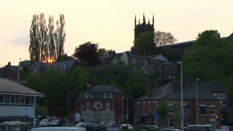CHESHIRE, UK - AUGUST 2012:A church on a hill with the sunset through the trees.