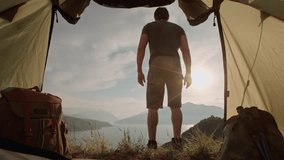 Back view of traveler stepping outside tent at sunrise camera inside fabric shelter concept of calm awakening solitude adventure beginning and connection with wilderness life - Powered by Shutterstock - Get 15% off with code: PIKWIZARD15