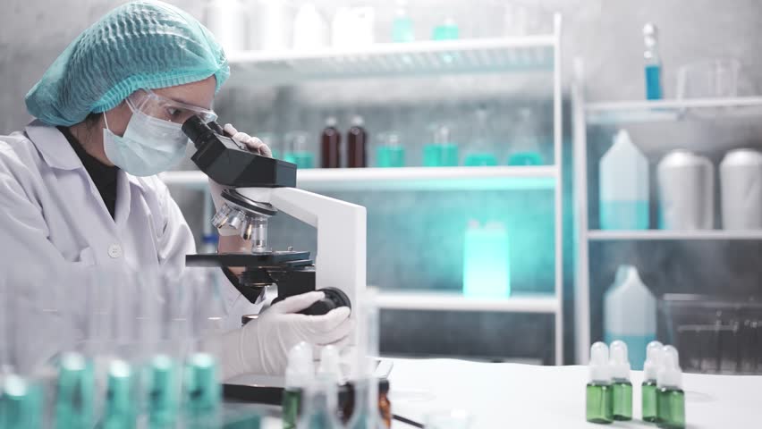 man woman scientist works in laboratory, analyzing chemical samples with glassware and microscope. research tools, experiments, pharmaceutical development. genetics lab pipette. medical studying DNA - Powered by Shutterstock - Get 15% off with code: PIKWIZARD15