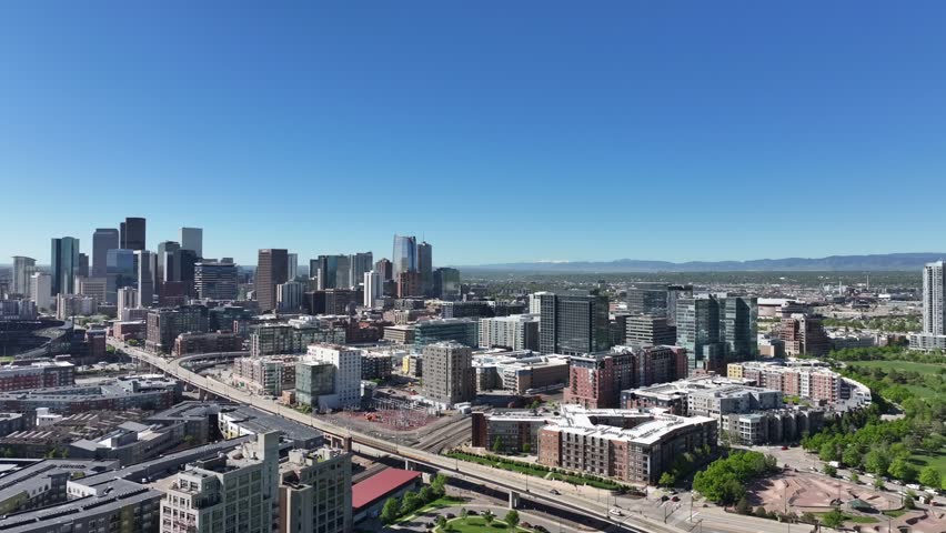 Aerial view of downtown Denver as the drone hovers with a clear blue sky above the city.