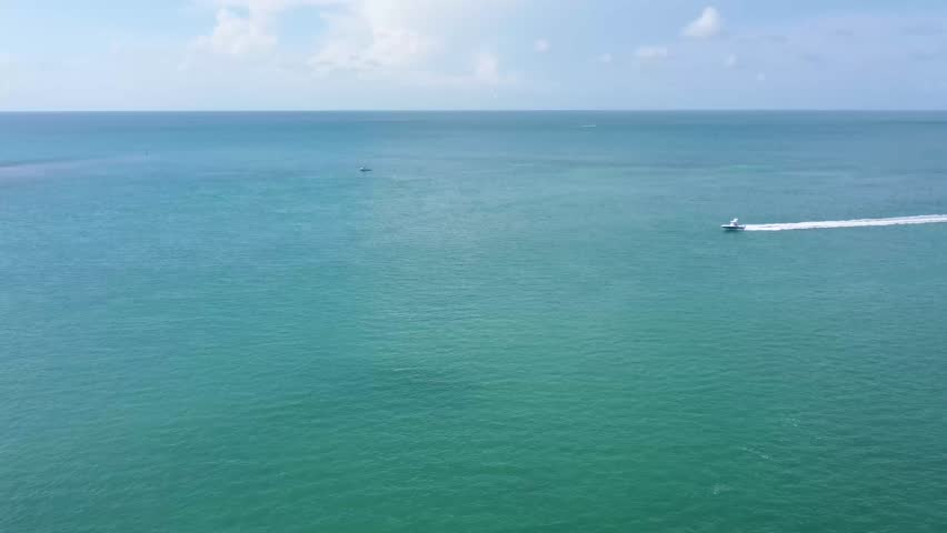Aerial drone view of the Seven Mile Bridge in Key West on a sunny Florida day, showcasing turquoise water, clear skies, and the iconic bridge stretching across the Keys