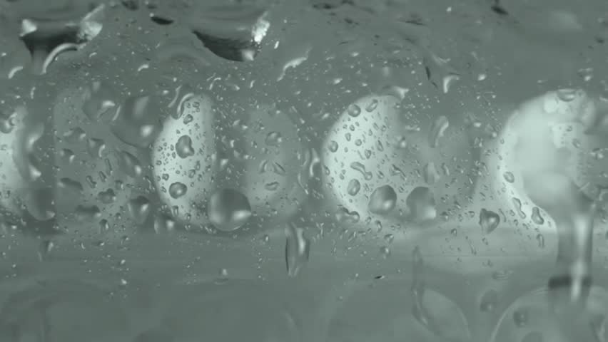 Raindrops on Wet Glass with Soft Bokeh Lights Behind Moody, Cinematic, 4K Loopable Background for Weather, Mood, or Urban Scenes