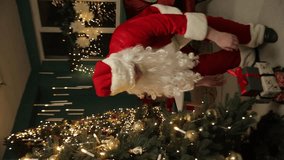 Santa arranging gifts under the Christmas tree. Vertical video. - Powered by Shutterstock - Get 15% off with code: PIKWIZARD15