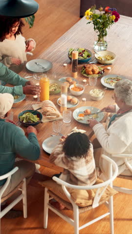 Lunch, thanksgiving and above of family in dining room for nutrition, bonding and festive gathering. Health, holiday season and food with people eating in home for reunion, relax and meal together