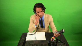 Office Worker Multitasks Phone Calls and Notes, Suited Businessman Handles Two Landlines with Ease, Corporate Professional Balances Talk Plus Writing, Busy Employee manages Dual Receivers Also Typing - Powered by Shutterstock - Get 15% off with code: PIKWIZARD15