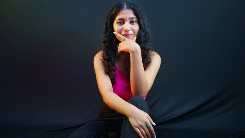 Curly Haired Beauty Poses Calmly inside Fashion Studio, Stylish Crop Top Model Smiles Gracefully in Portfolio, Classy Girl Radiates Charm During Photography, Diva Displays Joyful Expression for Camera