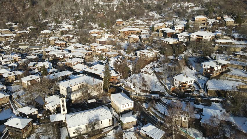 Aerial Winter Sunset view of Village of Kovachevitsa with Authentic nineteenth century houses, Blagoevgrad Region, Bulgaria