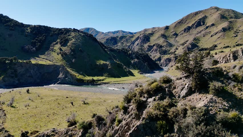 Aerial journey over serene mountain landscape with river valley and lush hills, New Zealand
